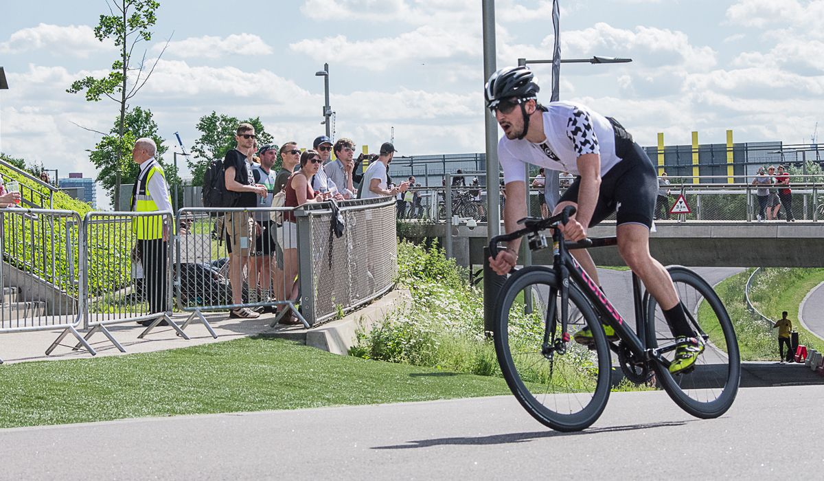 Road cyclist racing during a criterium race wearing Assos clothing