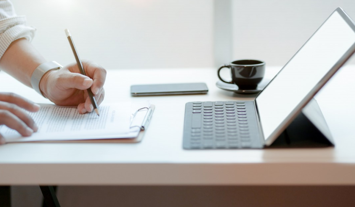 Man working on desk with iPad