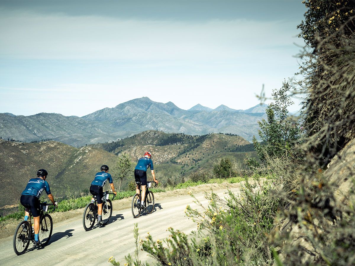 Group of cyclists riding on gravel