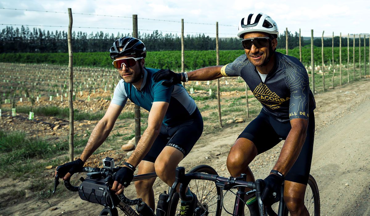 Two cyclists cycling in a group