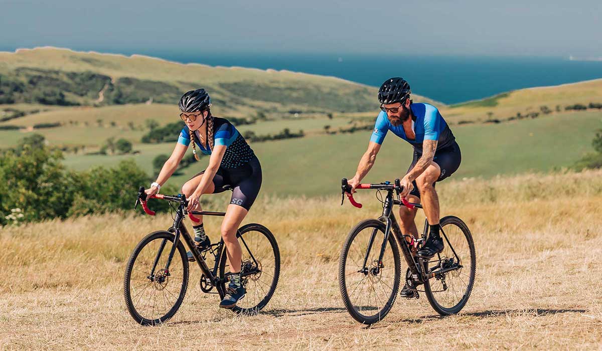 Two cyclists cycling on gravel