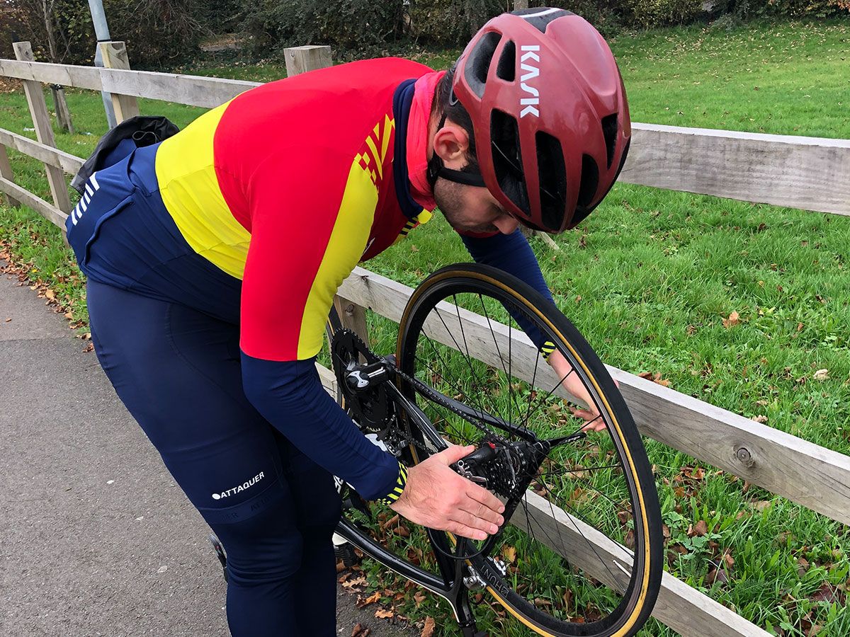 Cyclist changing flat tyre
