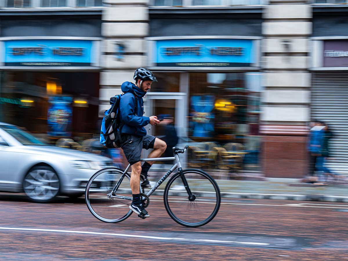 Cyclist cycling on phone