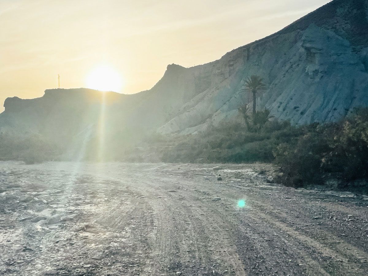 Sun shining on gravel road