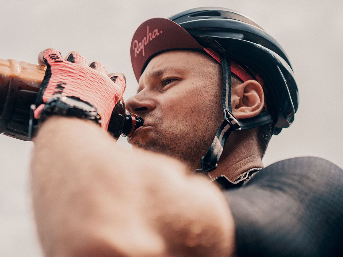 Male cyclist drinking